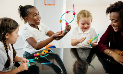 School children and their teacher doing a lesson with bendy toys